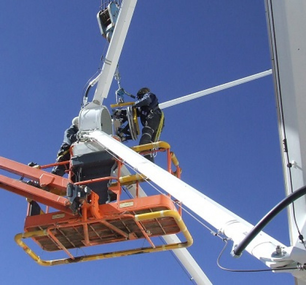Engineers installing a PI hexapod at a subreflector of an ALMA telescope  